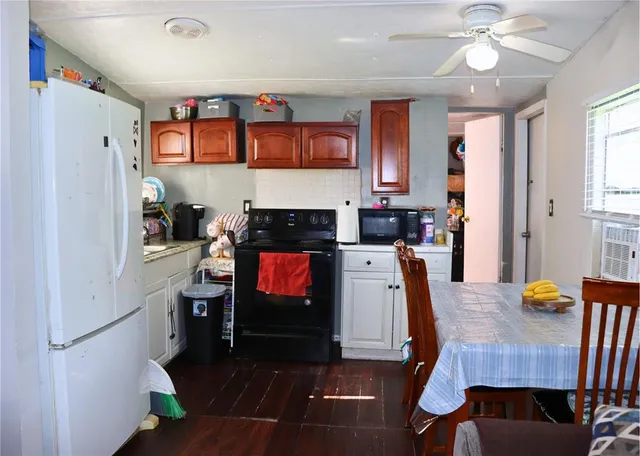 a view of kitchen with cabinets and wooden floor