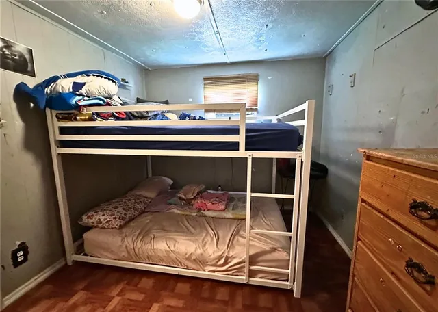 a bedroom with a bed and window