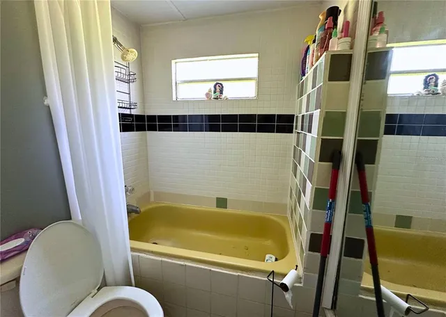 a bathroom with a bathtub and a window