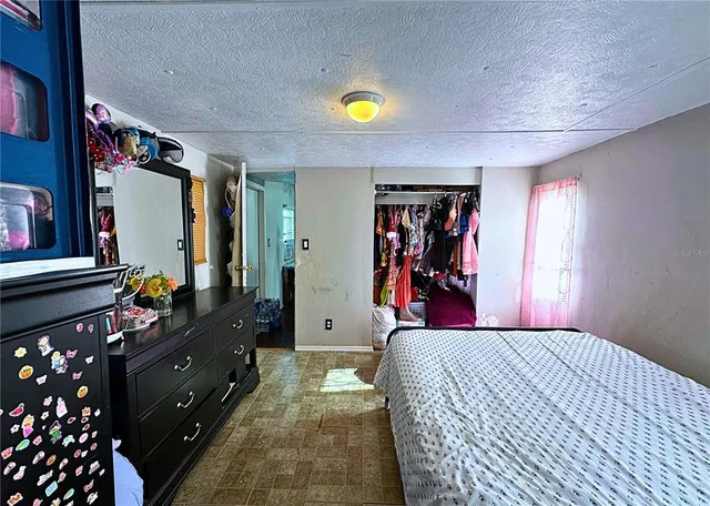 a bedroom with a bed and a dresser