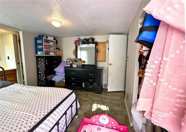 a bed room with a bed and a television