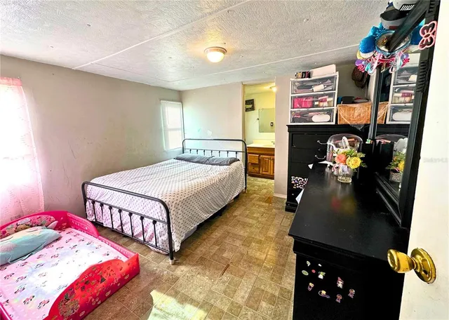 a bedroom with bed and a window