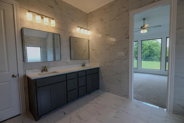 a bathroom with a double vanity sink and a mirror