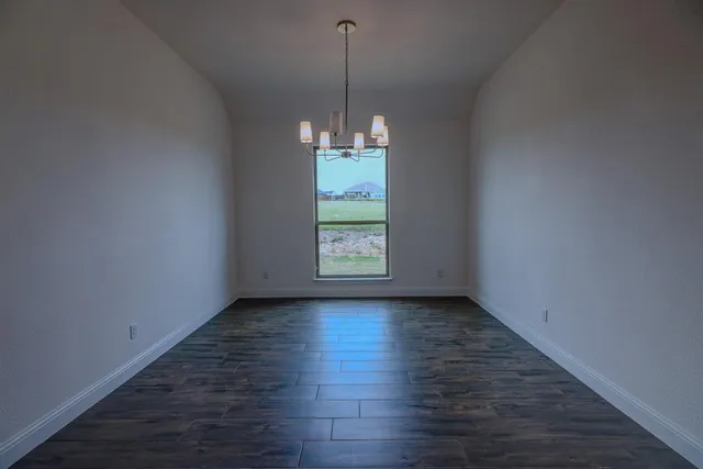 a view of a room window and wooden floor