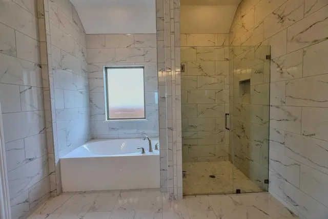 a bathroom with a bathtub and shower