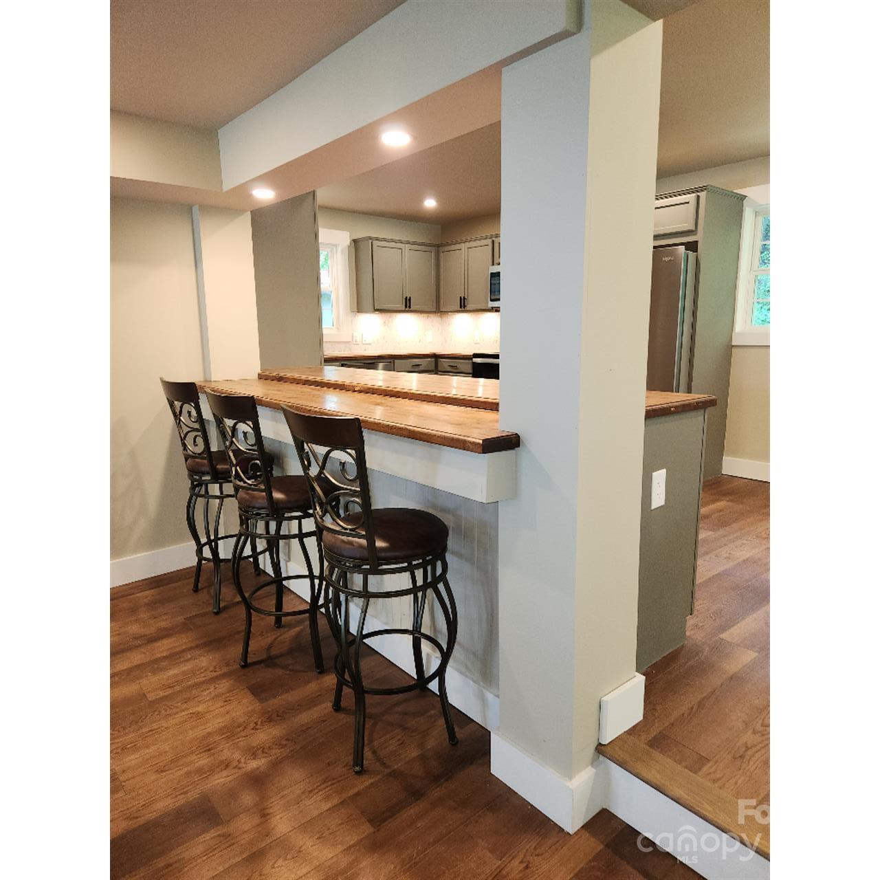 283 Robin Drive Marion, NC 28752 - Photo 13 of 30 a view of a dining area with furniture and wooden floor