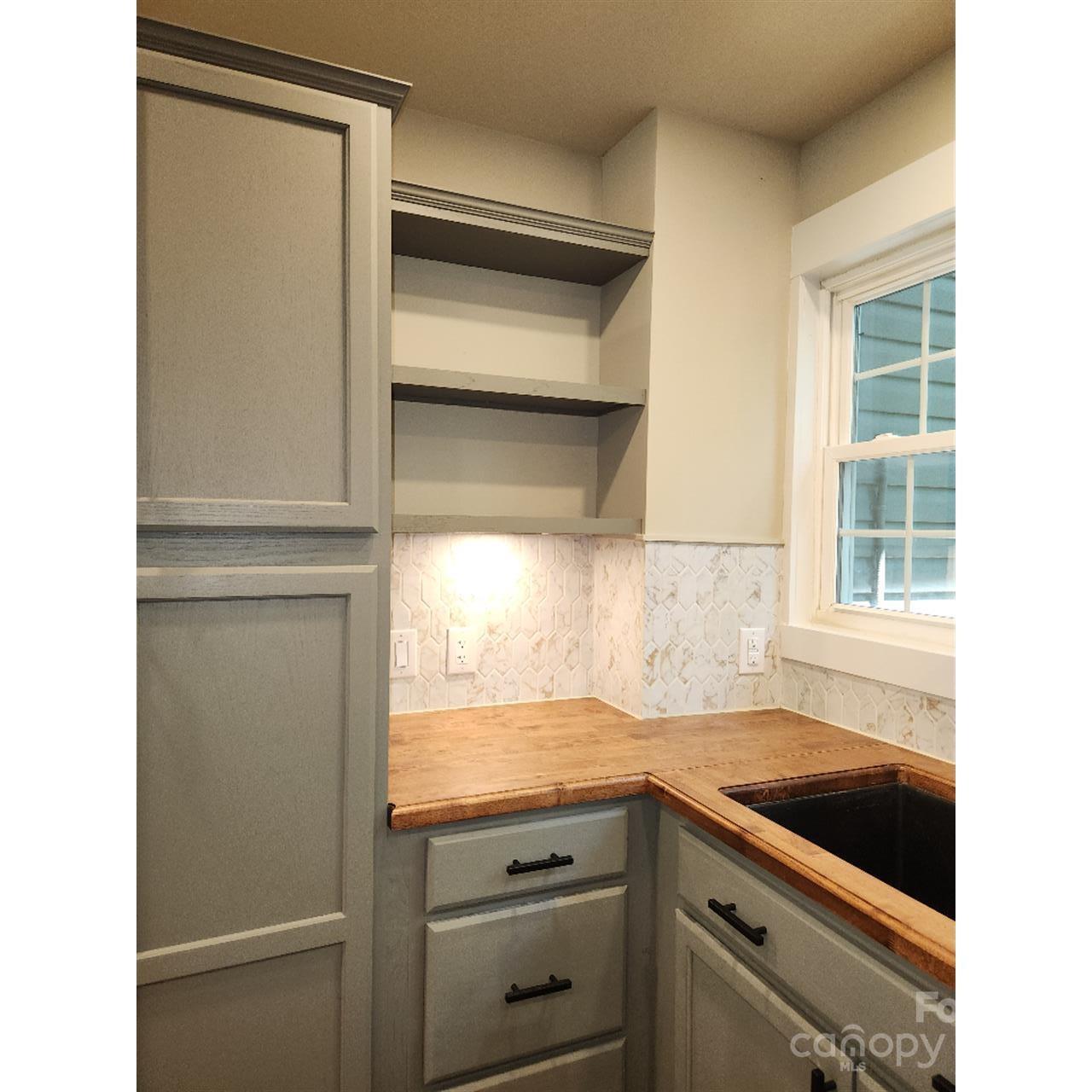 283 Robin Drive Marion, NC 28752 - Photo 9 of 30 a kitchen with a refrigerator and a sink