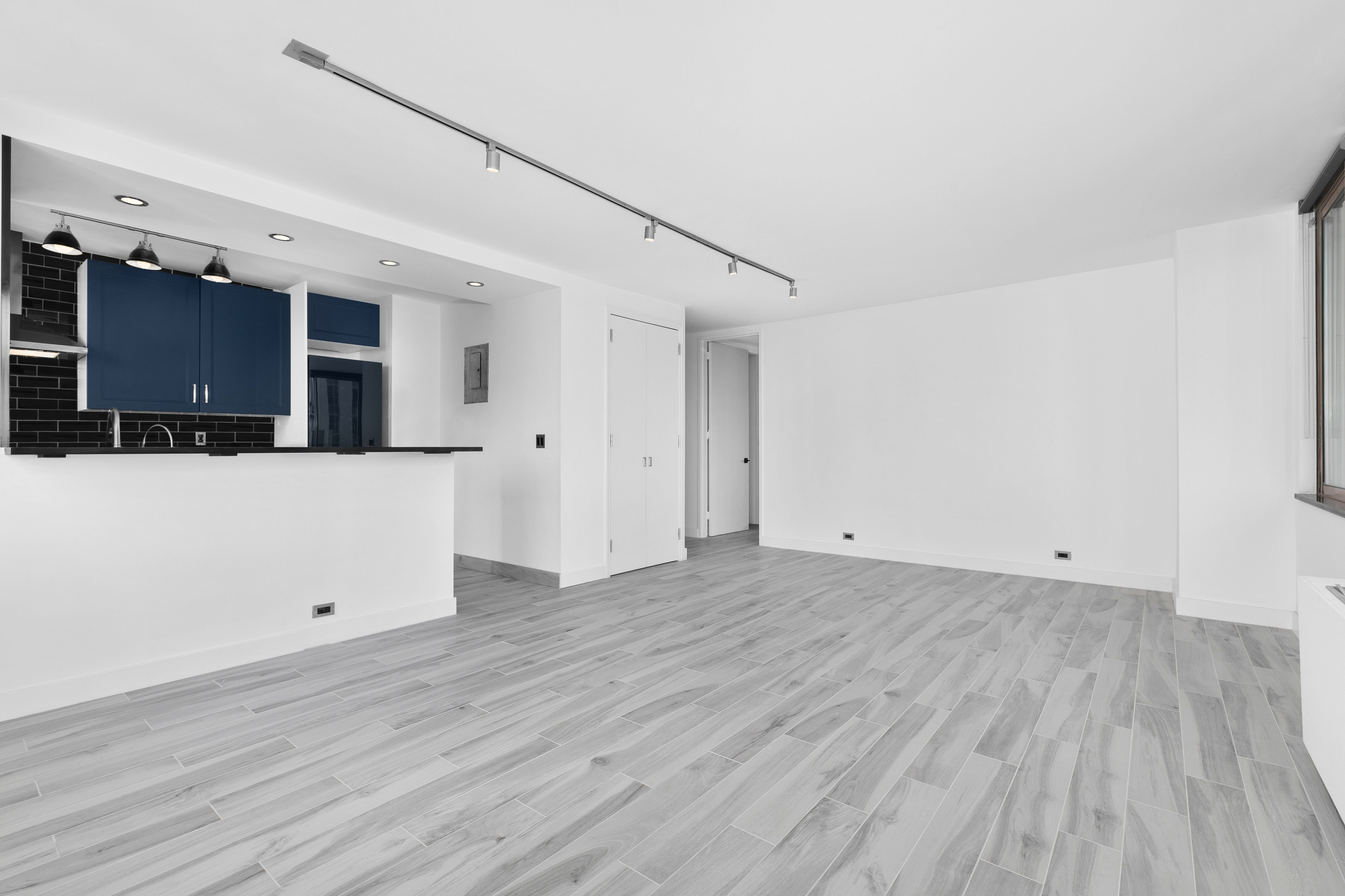 235 East 40th Street, Unit 26G Manhattan, NY 10016 - Photo 2 of 7 a view of a big room with wooden floor and windows