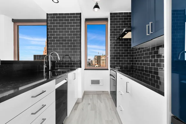 a view of a big room with wooden floor and windows