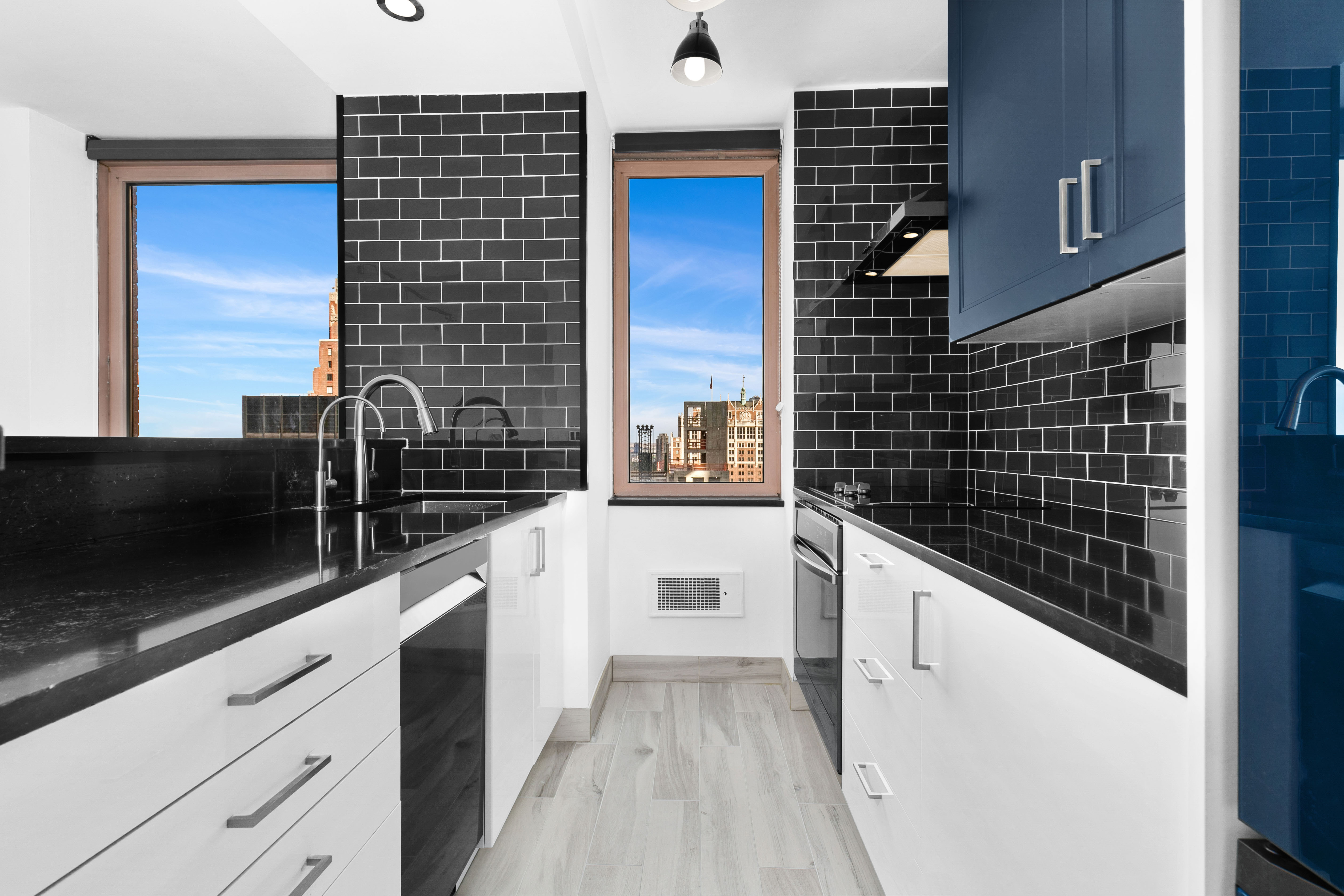 235 East 40th Street, Unit 26G Manhattan, NY 10016 - Photo 3 of 7 a kitchen with a sink and cabinets