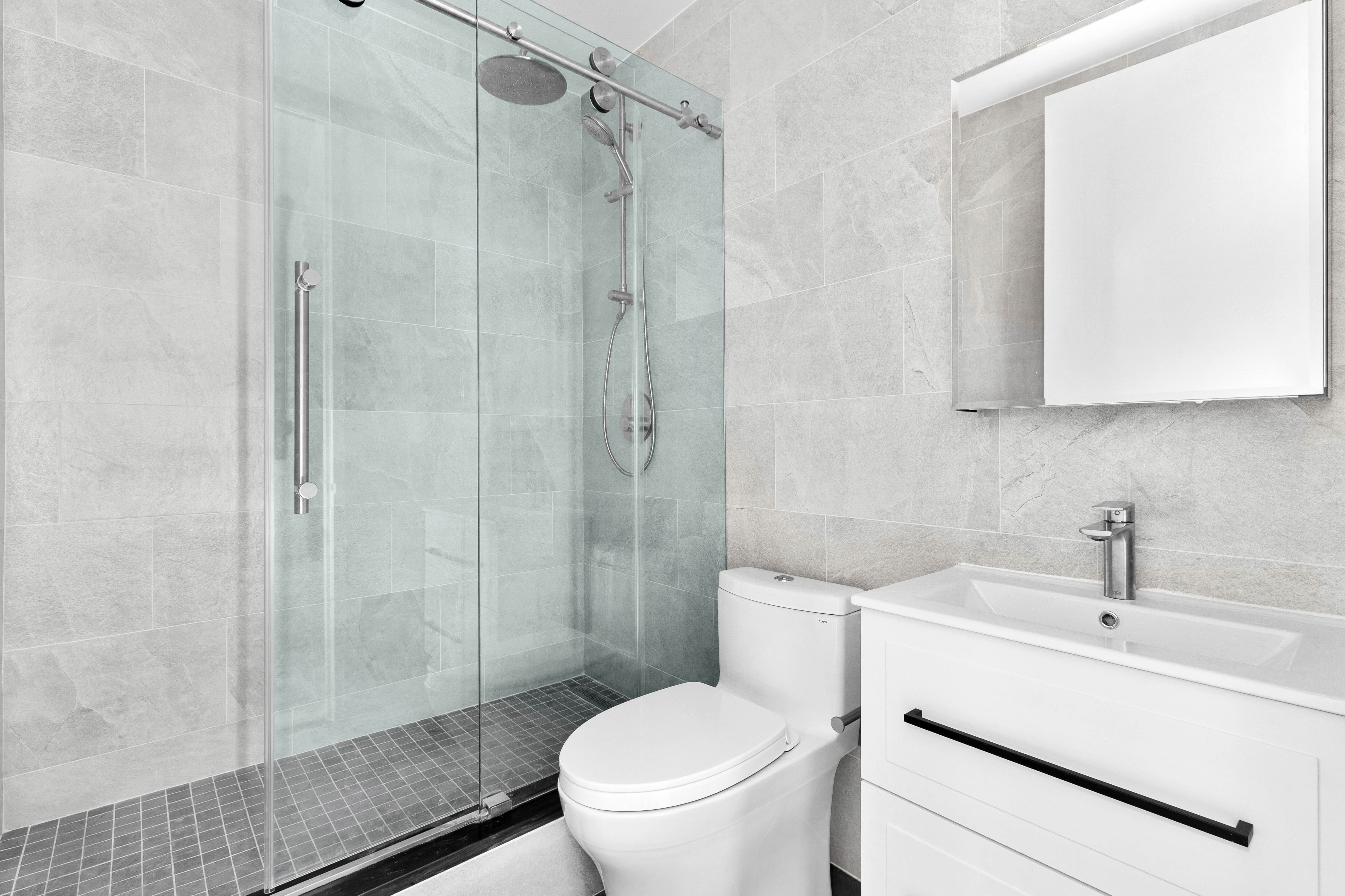 235 East 40th Street, Unit 26G Manhattan, NY 10016 - Photo 6 of 7 a bathroom with a sink toilet and shower