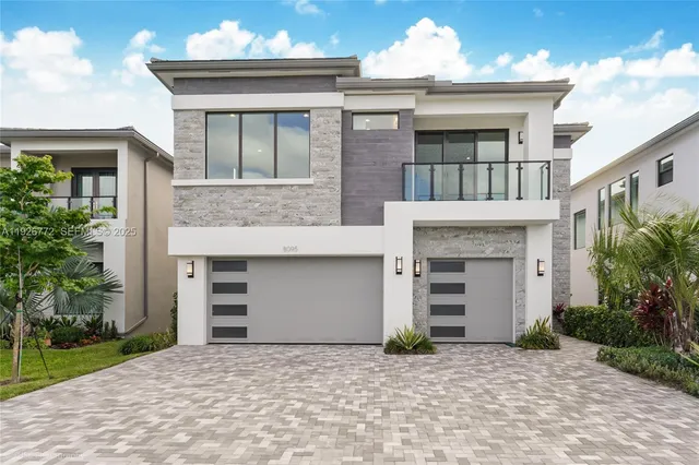 a front view of a house with a yard and a garage