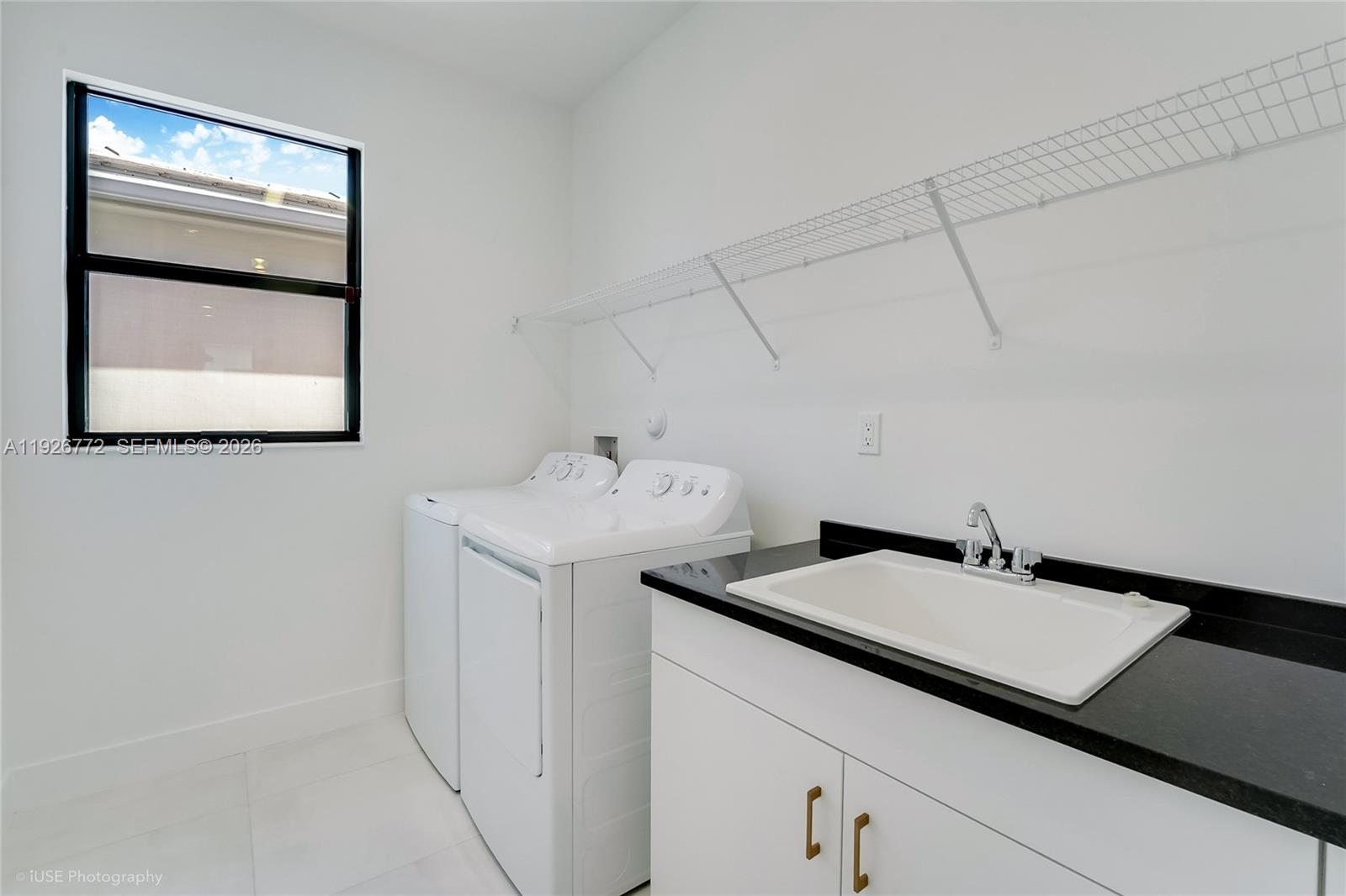 8095 Crystal Downs Avenue Boca Raton, FL 33434 - Photo 25 of 27 a utility room with a sink dryer and washer