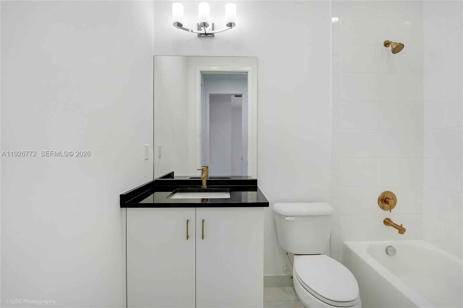 8095 Crystal Downs Avenue Boca Raton, FL 33434 - Photo 26 of 27 a bathroom with a granite countertop sink and a toilet