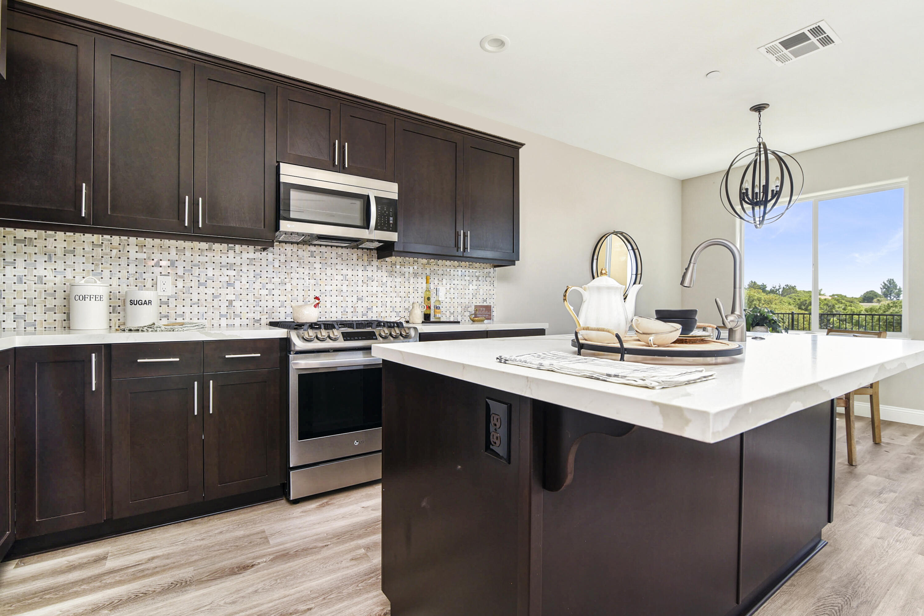 280 Oak Hill Drive Lompoc, CA 93436 - Photo 14 of 31 a kitchen with stainless steel appliances granite countertop a sink stove and microwave with wooden floor
