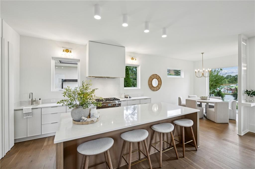 407 Linden Avenue Northeast, Unit A Atlanta, GA 30308 - Photo 12 of 65 a kitchen with a table and chairs in it