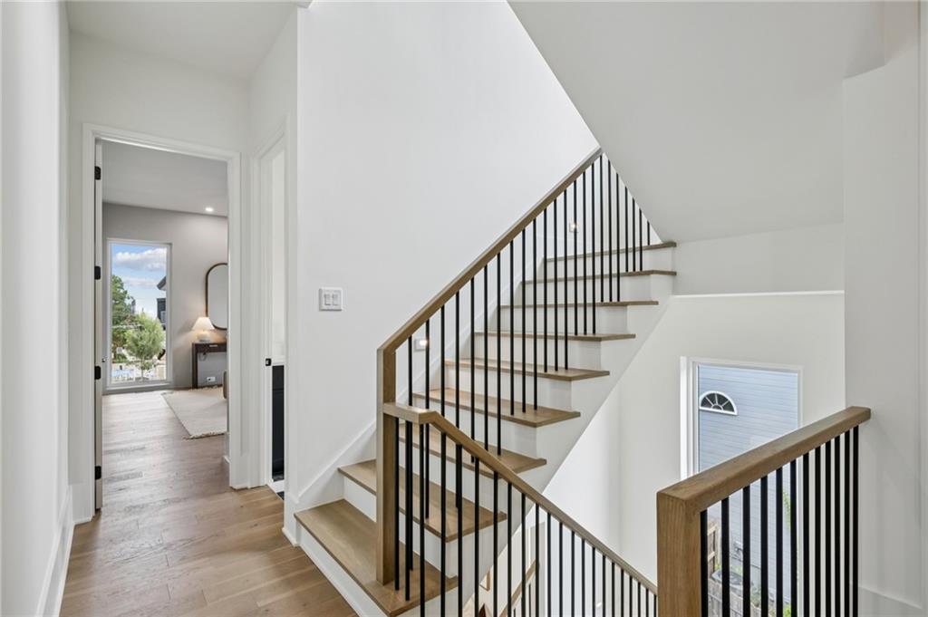 407 Linden Avenue Northeast, Unit A Atlanta, GA 30308 - Photo 23 of 65 a view of staircase with wooden floor and a rug