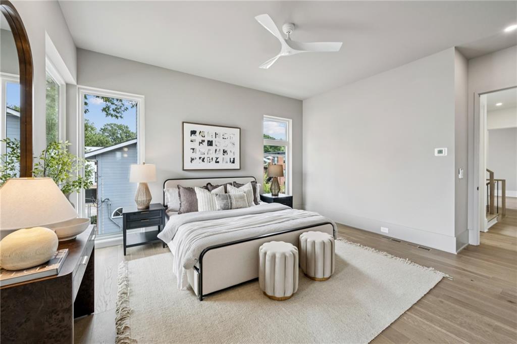 407 Linden Avenue Northeast, Unit A Atlanta, GA 30308 - Photo 25 of 65 a spacious bedroom with a bed and painting on the wall