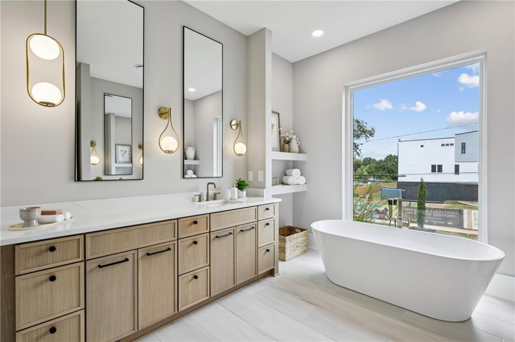 407 Linden Avenue Northeast, Unit A Atlanta, GA 30308 - Photo 26 of 65 a large spacious bathroom with a double vanity sink mirror and bathtub