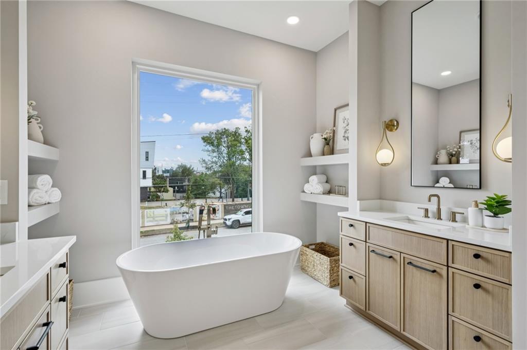 407 Linden Avenue Northeast, Unit A Atlanta, GA 30308 - Photo 27 of 65 a spacious bathroom with a tub sink and mirror
