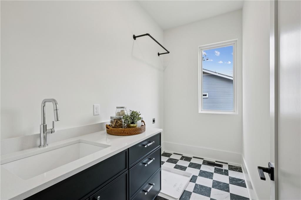 407 Linden Avenue Northeast, Unit A Atlanta, GA 30308 - Photo 33 of 65 a bathroom with a sink a mirror and a shower