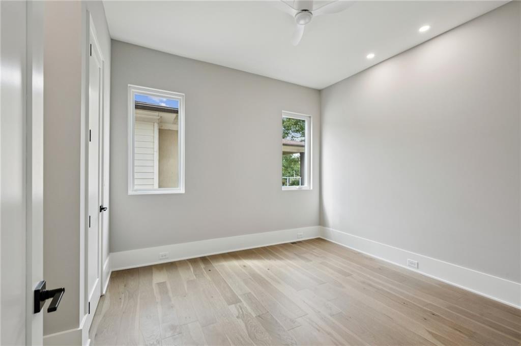 407 Linden Avenue Northeast, Unit A Atlanta, GA 30308 - Photo 34 of 65 an empty room with wooden floor and windows