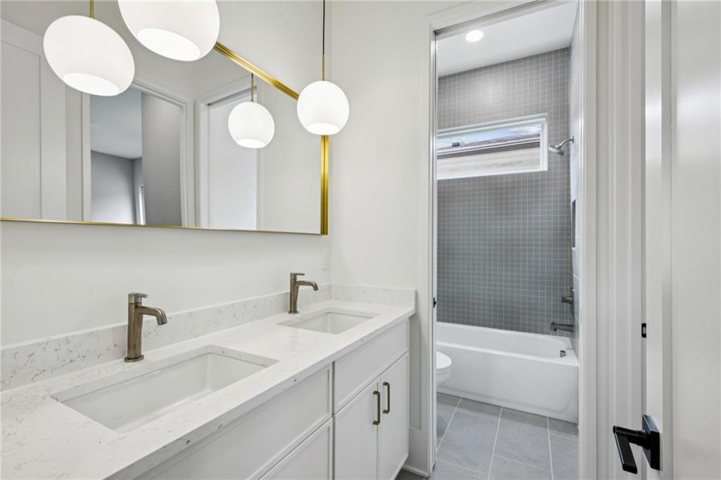 407 Linden Avenue Northeast, Unit A Atlanta, GA 30308 - Photo 35 of 65 a bathroom with a sink a toilet and a mirror