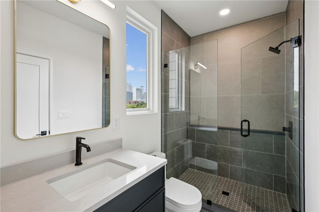 407 Linden Avenue Northeast, Unit A Atlanta, GA 30308 - Photo 40 of 65 a bathroom with a sink a toilet and shower