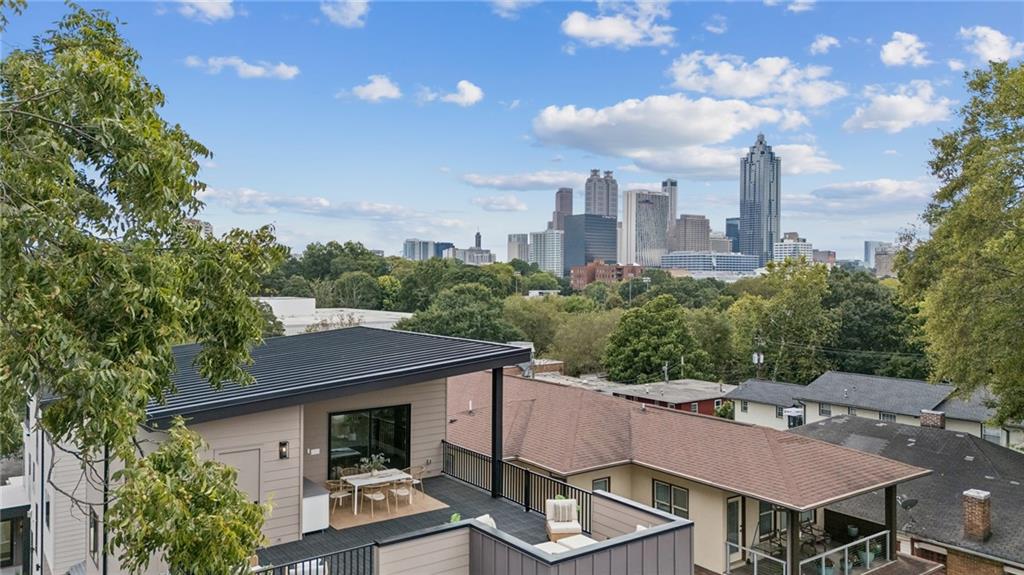 407 Linden Avenue Northeast, Unit A Atlanta, GA 30308 - Photo 46 of 65 a view of a patio with table and chairs and potted plants