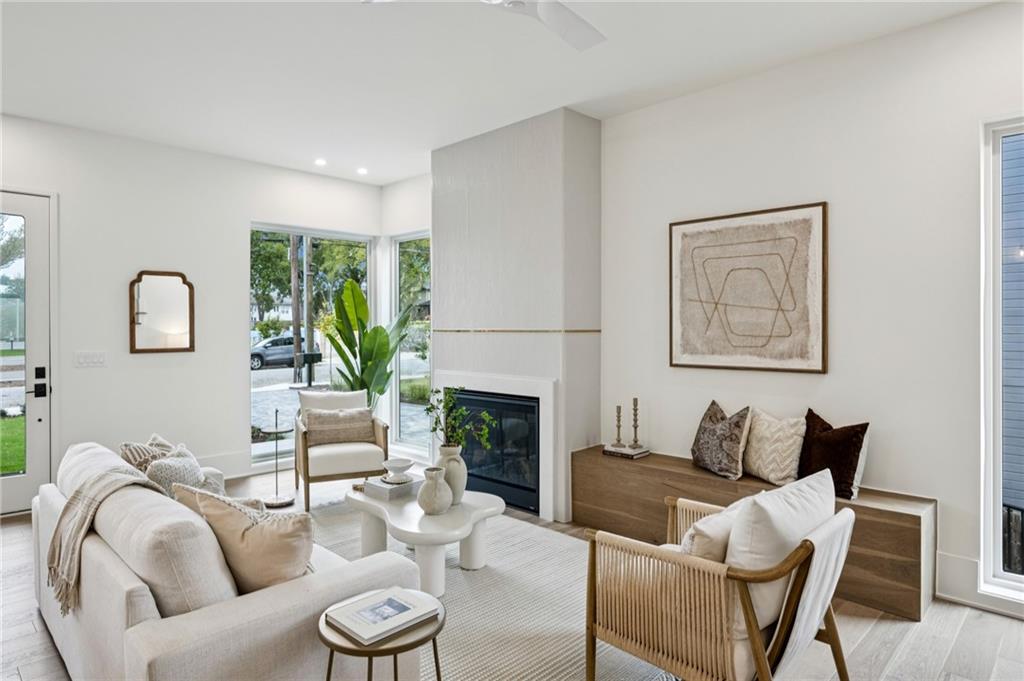 407 Linden Avenue Northeast, Unit A Atlanta, GA 30308 - Photo 7 of 65 a living room with furniture a fireplace and a large window