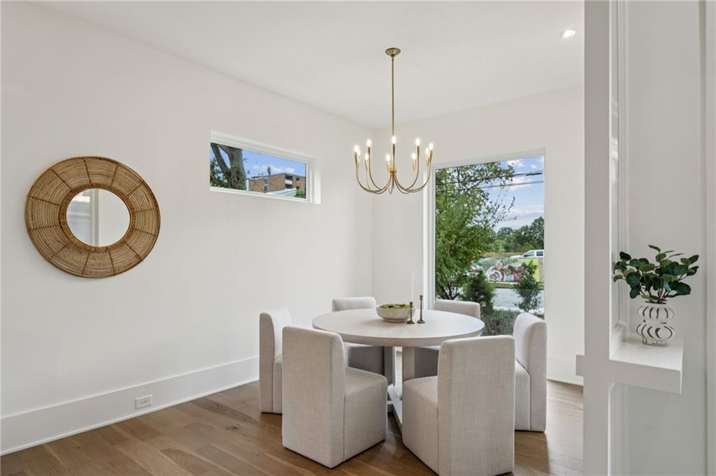 407 Linden Avenue Northeast, Unit A Atlanta, GA 30308 - Photo 8 of 65 a view of a dining room with furniture wooden floor and chandelier