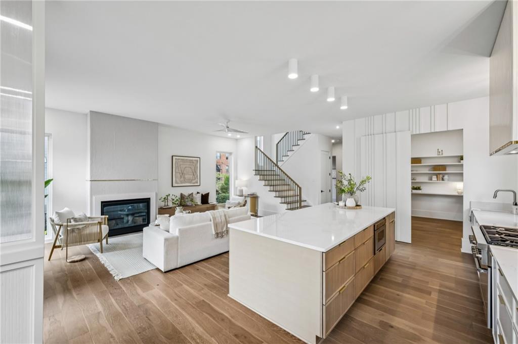 407 Linden Avenue Northeast, Unit A Atlanta, GA 30308 - Photo 10 of 65 a living room with furniture and a fireplace