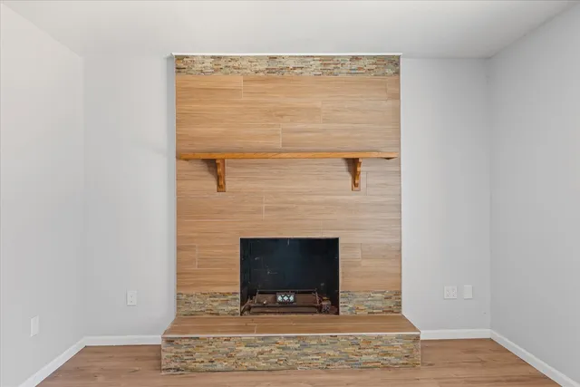 a view of fireplace and wooden floor