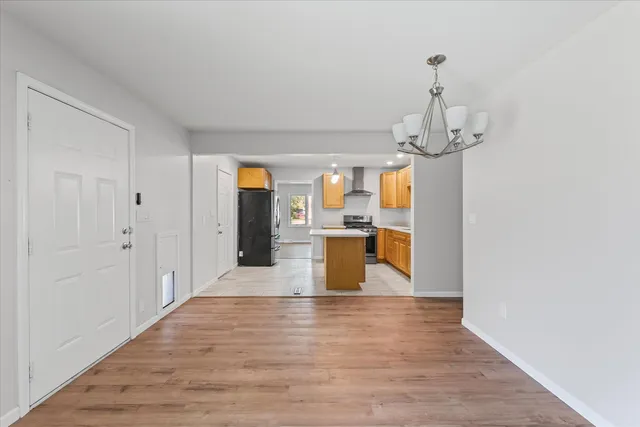a view of a living room and kitchen with wooden floor