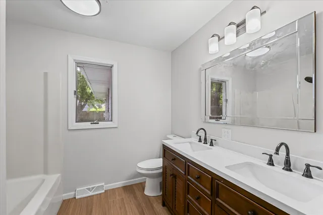 a bathroom with a granite countertop sink vanity and a mirror