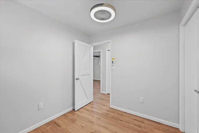 a view of a room with wooden floor