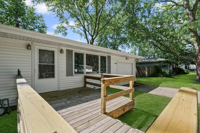 a view of a house with backyard and a patio