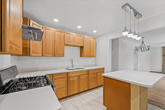 a kitchen that has a sink and a stove in it