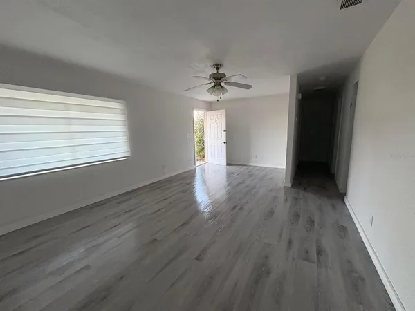 wooden floor in an empty room with a window