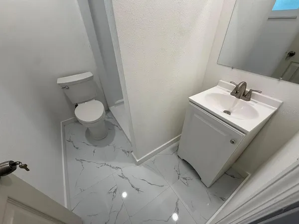 a bathroom with a sink toilet and vanity