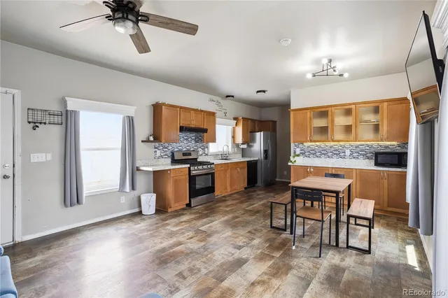 a kitchen with a cabinets and chairs in it