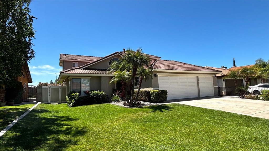 20257 Edmund Road Riverside, CA 92508 - Photo 3 of 53 a front view of a house with a yard and garage