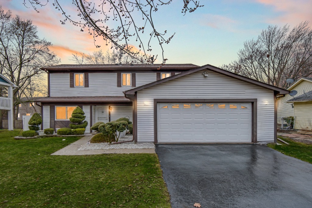 40 Huntingwood Road Matteson, IL 60443 - Photo 3 of 27 a front view of a house with a garden and garage