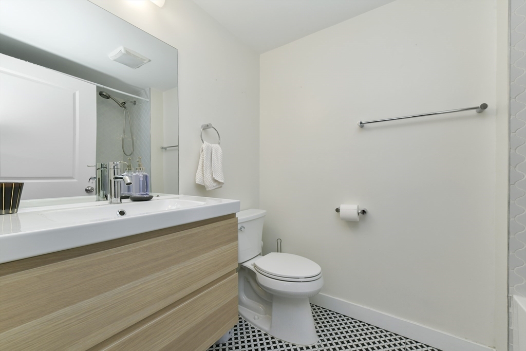 47 Sargent Street, Unit 3 Boston, MA 02125 - Photo 13 of 21 a bathroom with a sink mirror vanity and toilet