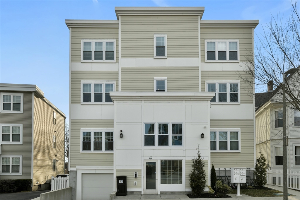 47 Sargent Street, Unit 3 Boston, MA 02125 - Photo 18 of 21 a front view of a building with a lot of windows