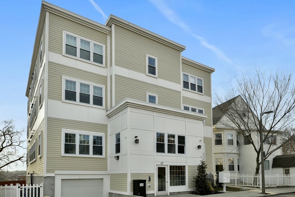 47 Sargent Street, Unit 3 Boston, MA 02125 - Photo 19 of 21 a front view of a building with a yard