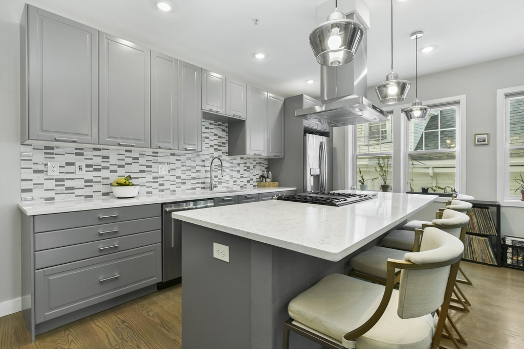 47 Sargent Street, Unit 3 Boston, MA 02125 - Photo 5 of 21 a kitchen with a table chairs stove and cabinets