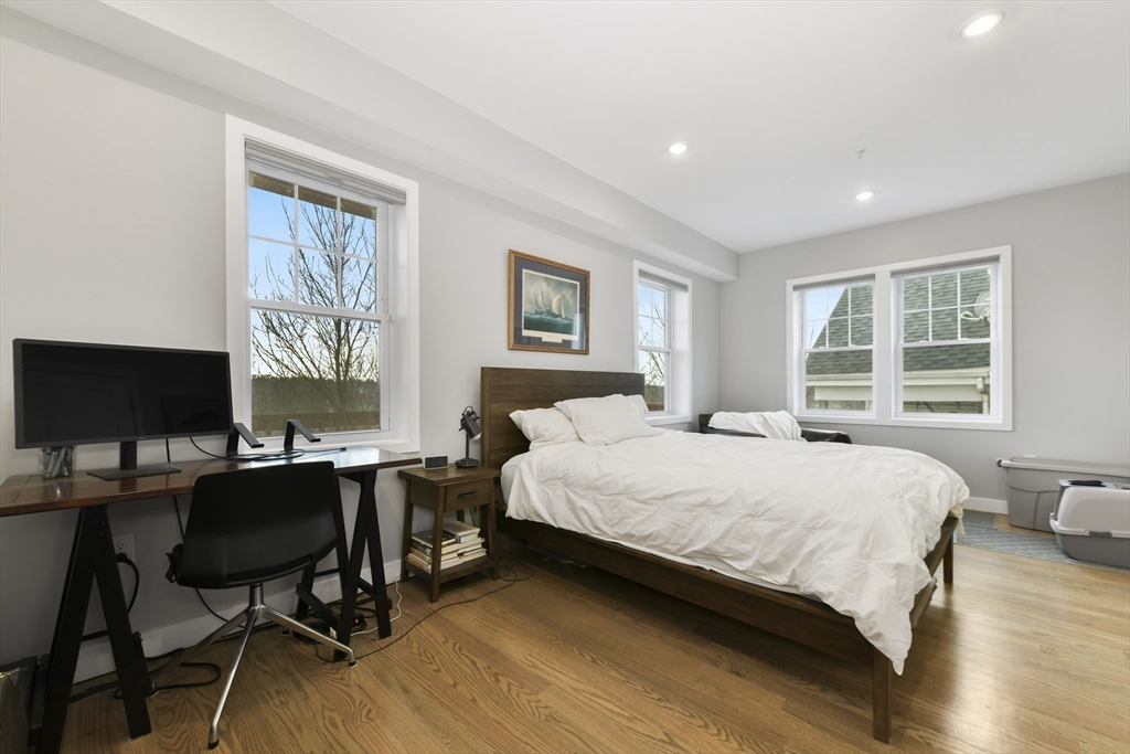 47 Sargent Street, Unit 3 Boston, MA 02125 - Photo 9 of 21 a bedroom with a bed computer on desk and a window