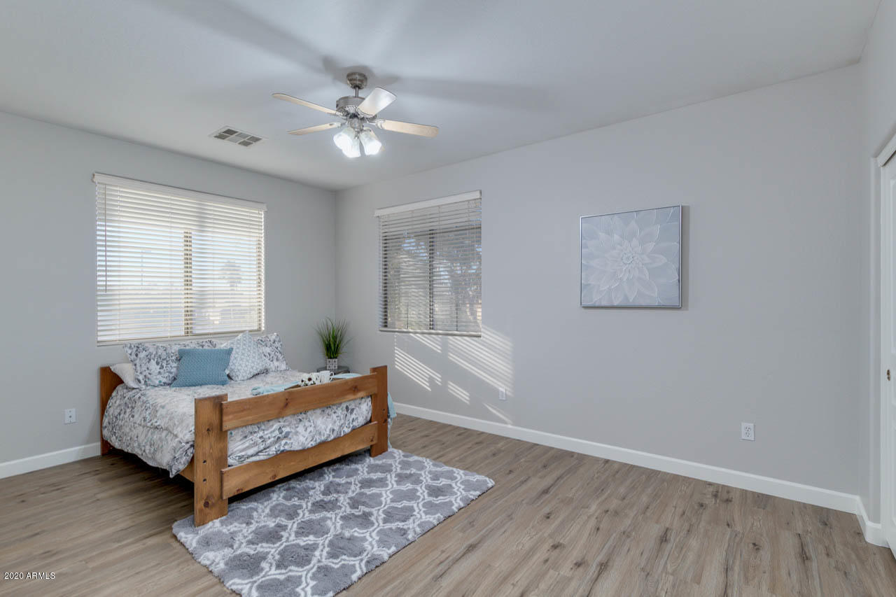 3315 East Los Altos Road Gilbert, AZ 85297 - Photo 45 of 66 a living room with a bed furniture and a window