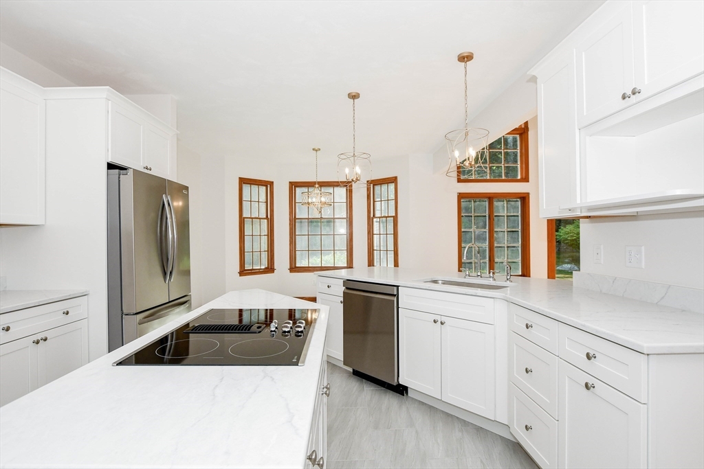 7 Upland Way Marion, MA 02738 - Photo 13 of 42 a kitchen that has a lot of white cabinets and stainless steel appliances